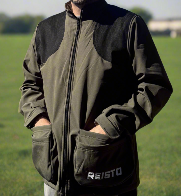 Clay pigeon shooter wearing the REISTO® Shooting Jacket during winter training, showcasing the best winter shooting jacket for cold-weather shooting sessions.